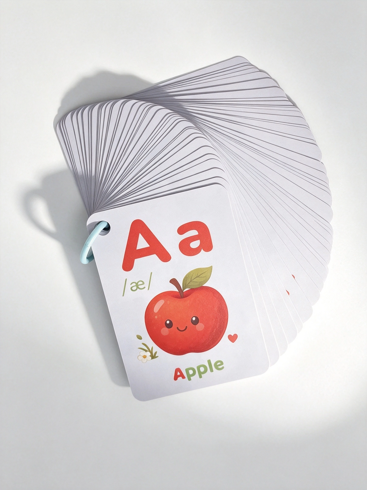 Full deck of wipe-clean PVC flash cards fanned on a ring, with the A for Apple card on top