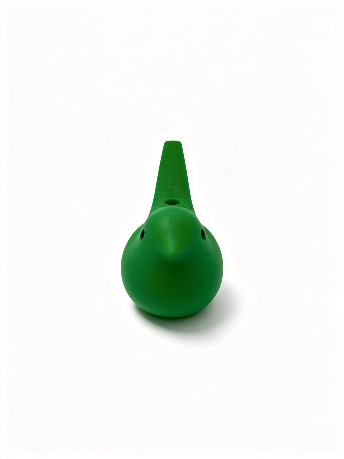 Green bird ocarina head-on, rounded body with two small holes and mouthpiece pointing upwards