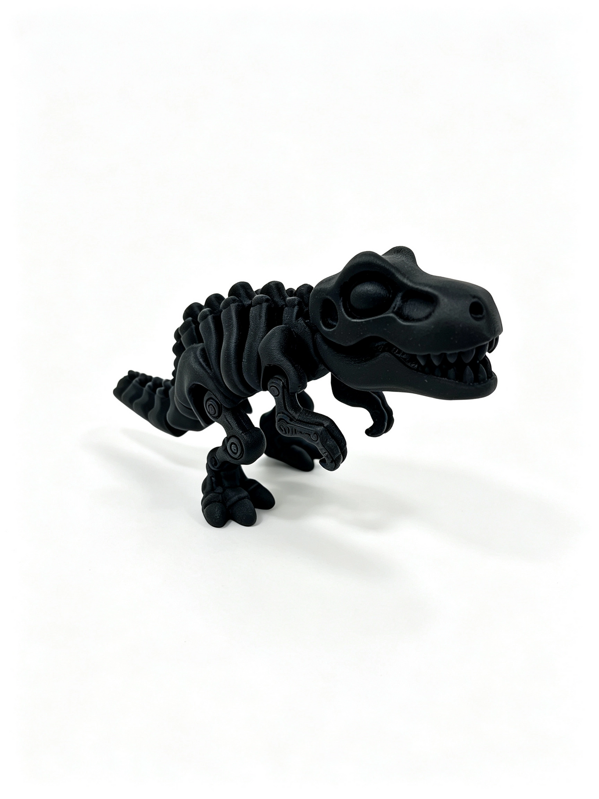 Black 3D-printed articulated T-Rex skeleton standing side-on with jaws open