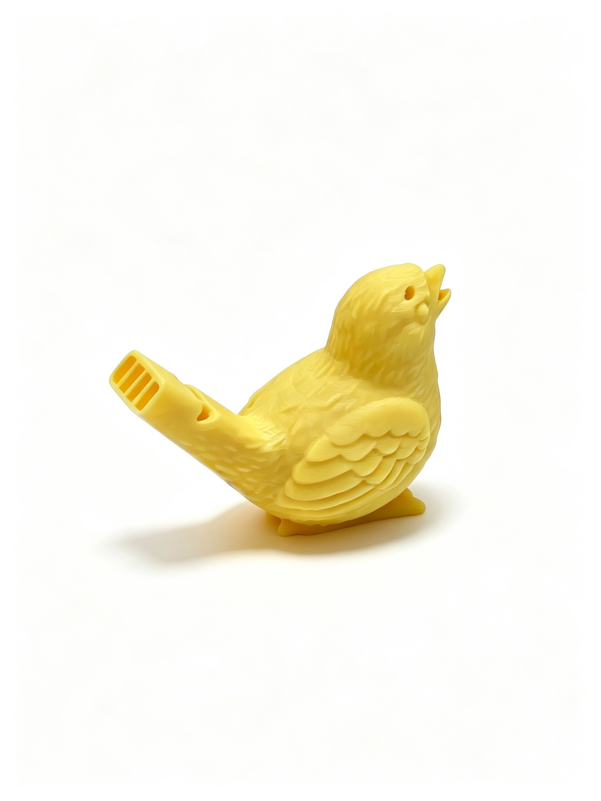 Yellow 3D-printed singing bird water whistle, beak open, whistle tube at its tail