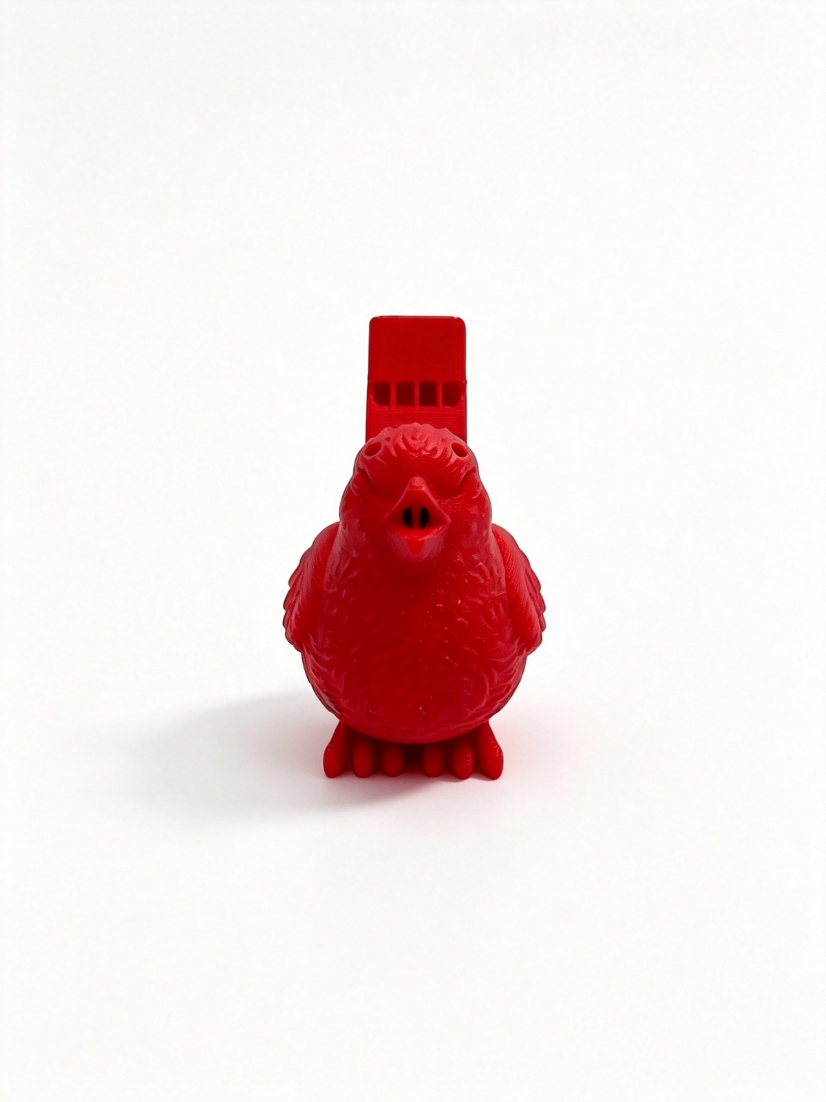 Red bird whistle head-on, round feathered body and whistle mouthpiece above its head