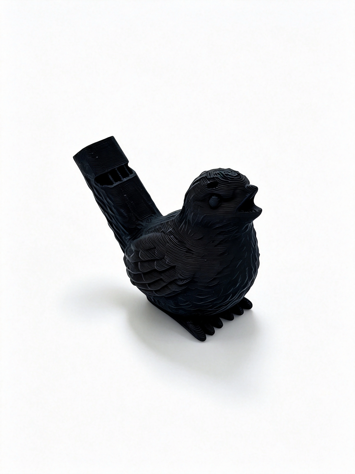 Black 3D-printed bird water whistle, three-quarter view with tail whistle to the left