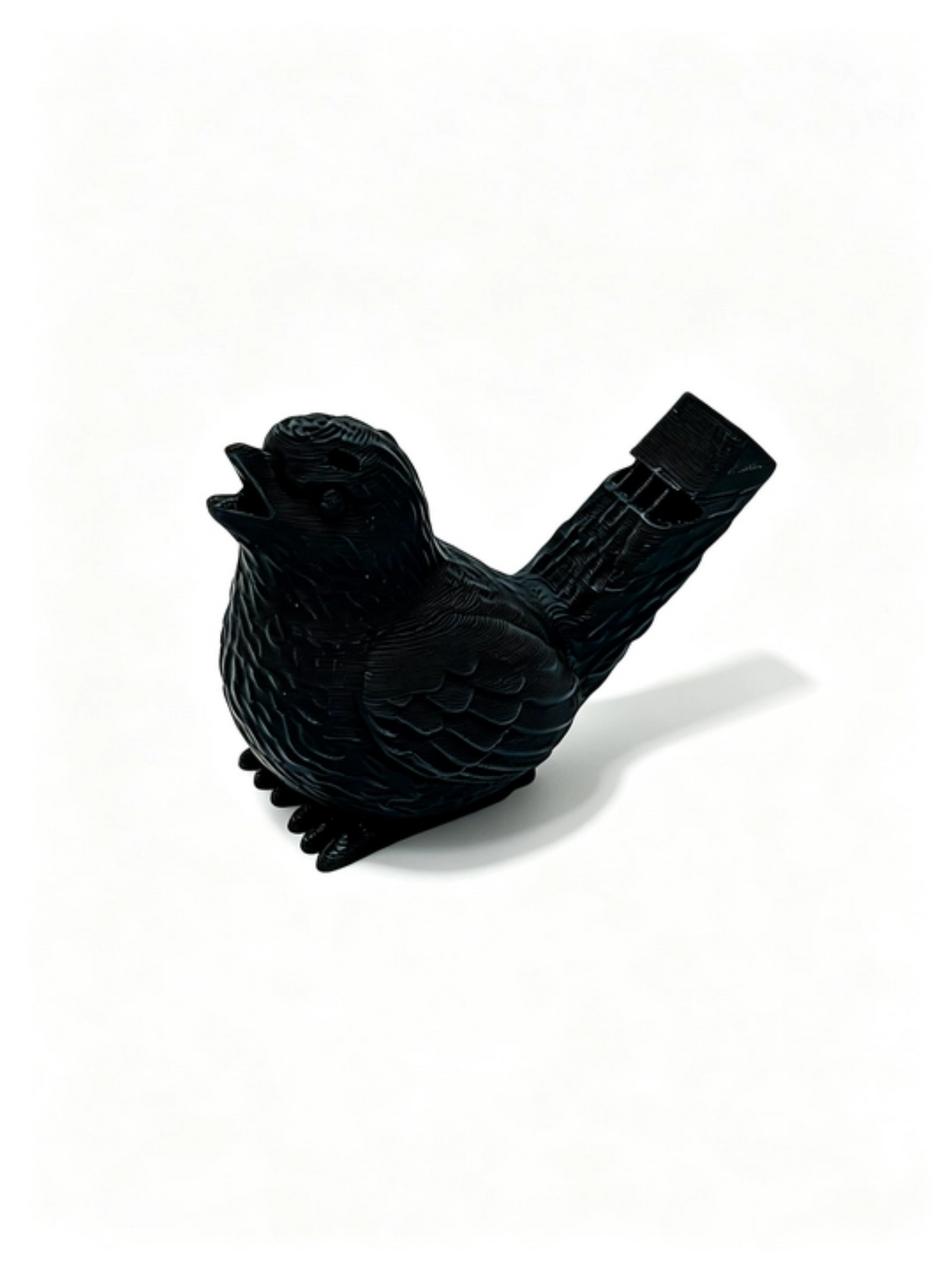 Black bird whistle side-on facing left, whistle mouthpiece angled up to the right