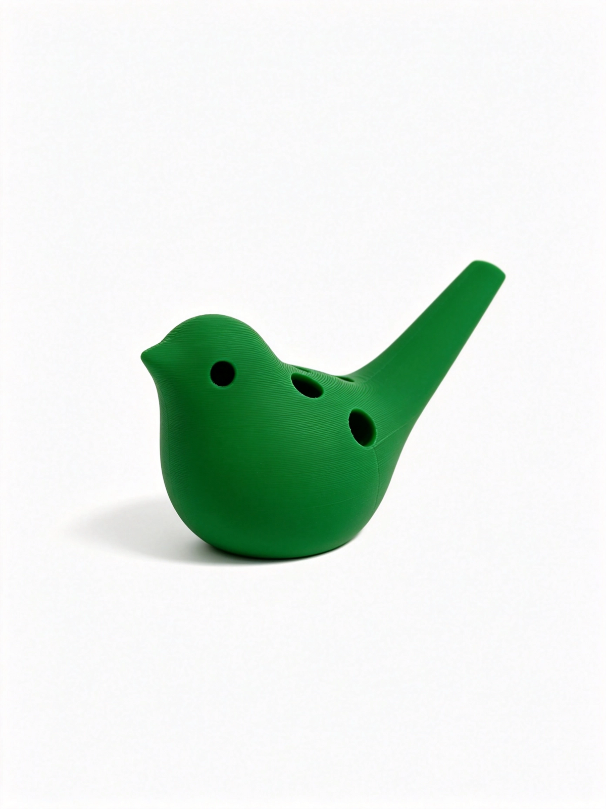 Green bird ocarina facing left, three finger holes on the body and mouthpiece raised right